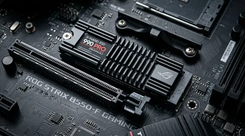 Macro close-up of NVMe M.2 solid state drive with finned aluminum heatsink installed on motherboard